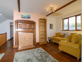 A living room with a fireplace and sofa at 1 Eastdon Cottages in Exeter