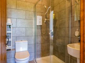 A bathroom featuring a shower, toilet and sink at 1 Eastdon Cottages, Exeter
