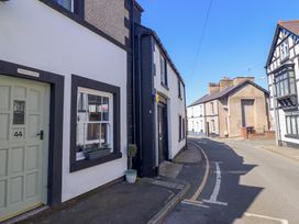 A street view with houses along the road including Derwen House in Llangollen