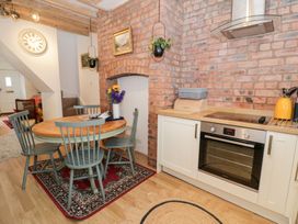 A kitchen with a round table and chairs at Derwen House Llangollen