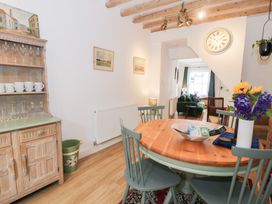 A dining room with a table and chairs at Derwen House in Llangollen
