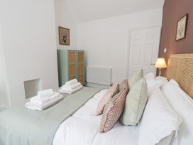 A bedroom with a bed and towels at Derwen House in Llangollen