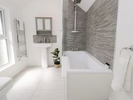 A bathroom with a bathtub and sink at Derwen House in Llangollen