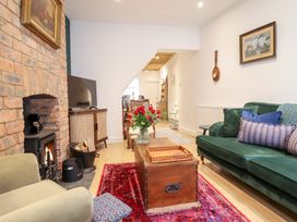 A living room with a fireplace and a coffee table at Derwen House in Llangollen