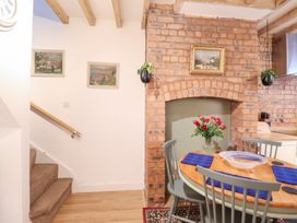 A dining area with a table and chairs at Derwen House in Llangollen