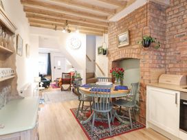 A kitchen with a dining table and chairs at Derwen House Llangollen