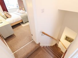 A staircase leading to a bedroom at Derwen House in Llangollen