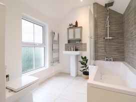 A bathroom with a bathtub and shower at Derwen House in Llangollen