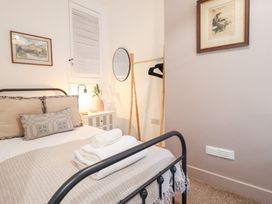 A bedroom with a bed and nightstand at Derwen House in Llangollen