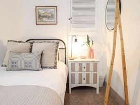 A bedroom with a bed and nightstand at Derwen House Llangollen