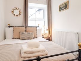 A bedroom with a bed and decorative pillows at Derwen House in Llangollen