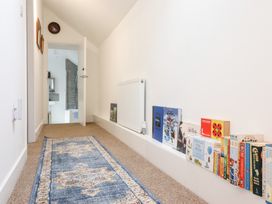 A hallway with books on the floor at Derwen House in Llangollen