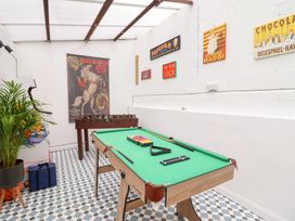 A games room with a pool table and foosball table at Derwen House in Llangollen