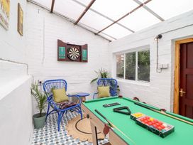 A snug with a billiard table and darts board at Derwen House in Llangollen