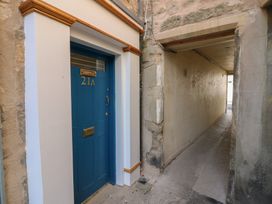 A doorway with number 21A and a pathway at 21A High Street Jedburgh