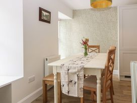 A dining room with a table and chairs at 21A High Street in Jedburgh