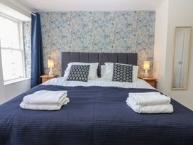 A bedroom with a bed and bedside tables at 21A High Street in Jedburgh