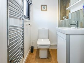 A bathroom with a toilet sink and heated towel rail at Sailing Home in Porthmadog