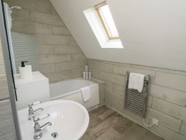 A bathroom with a bathtub sink towel rail and a skylight window at Lewis Lodge in St Ann's Chapel