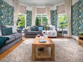 A living room with a gray sofa and coffee table at Rosemount Boutique in Windermere