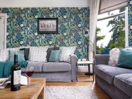 A living room with sofas and a wine bottle at Rosemount Boutique Windermere