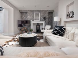 A living room with a sofa and coffee table at Rosemount Boutique Windermere