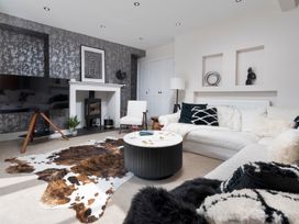 A living room with a sofa and a coffee table at Rosemount Boutique Windermere