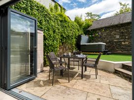 An outdoor patio with a table and chairs at Rosemount Boutique in Windermere