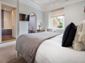 A bedroom with a bed and a television at Rosemount Boutique in Windermere