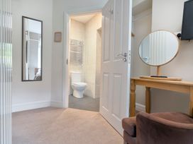 A bathroom with a toilet and hand towel rail at Rosemount Boutique in Windermere