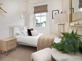 A bedroom with a bed and a nightstand at Rosemount Boutique in Windermere