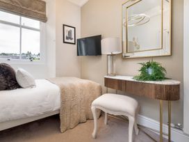A bedroom with a bed and small table at Rosemount Boutique Windermere