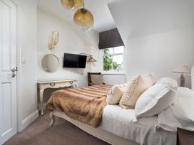 A bedroom with a bed and television at Rosemount Boutique in Windermere