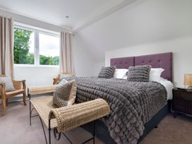 A bedroom featuring a bed with pillows and a window at Rosemount Boutique in Windermere