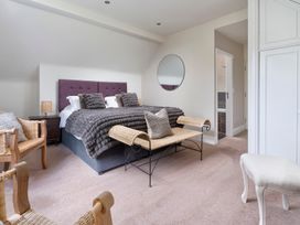 A bedroom with a bed and seating area at Rosemount Boutique in Windermere