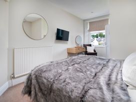 A bedroom with a bed, television, and window at Rosemary Boutique in Windermere