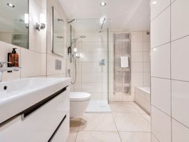 A bathroom with a sink, toilet, and shower at Rosemount Boutique in Windermere