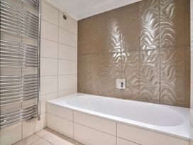 A bathroom with a bathtub and radiator at Rosemount Boutique in Windermere