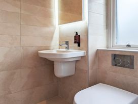A bathroom with a sink and toilet at Rosemount Boutique in Windermere