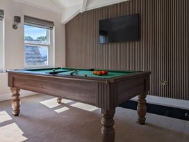 A game room with a pool table and television at Rosemount Boutique in Windermere