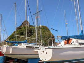 Sailboats docked at a marina with a hill in the background at Hollycombe, Ilfracombe