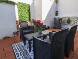A seating area with chairs and a table in a garden at Hollycombe Ilfracombe