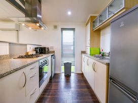 A kitchen with a gas stove oven microwave dishwasher and refrigerator at Kingfisher Ramsey Huntingdon