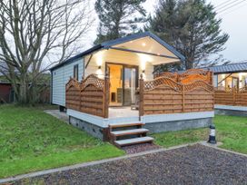 A small cabin with wooden fencing on a raised platform with steps leading to the door at MUSSENDEN CABIN Magilligan near Castlerock