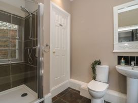 A bathroom with a shower enclosure toilet sink and mirror at Buckland House and Annex Lower Durston near Taunton