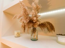 A shelf with pampas grass in a vase and candles at 59 Moorland Road Scarborough