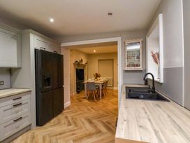 A kitchen with a refrigerator and sink at 59 Moorland Road Scarborough