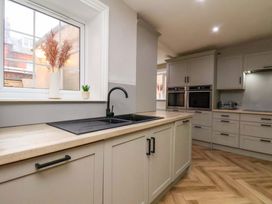 A kitchen with a sink and cabinets at 59 Moorland Road in Scarborough