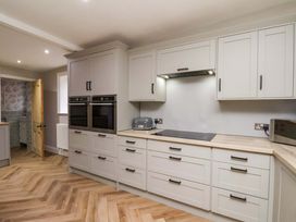 A kitchen with cabinets and appliances at 59 Moorland Road Scarborough