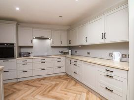 A kitchen with cabinets and appliances at 59 Moorland Road Scarborough